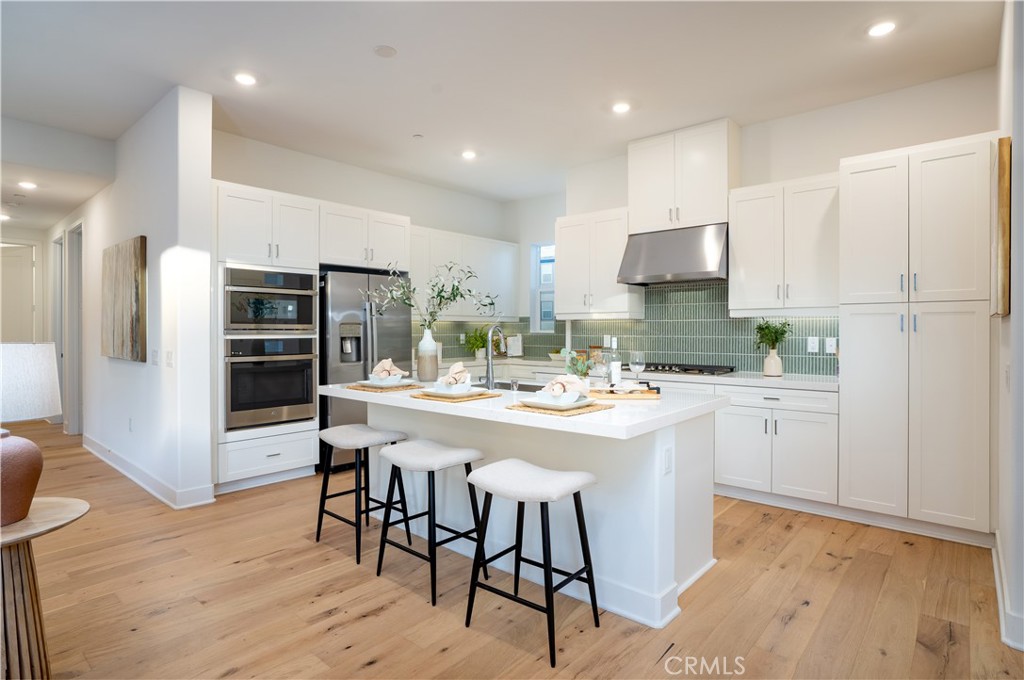 113 Junco Irvine, CA 92618 - Photo 11 of 47 a kitchen with stainless steel appliances kitchen island granite countertop a refrigerator and a stove top oven