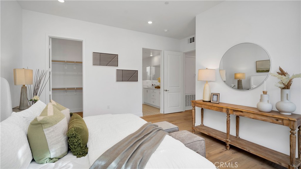113 Junco Irvine, CA 92618 - Photo 21 of 47 a spacious bedroom with a bed a mirror and dresser