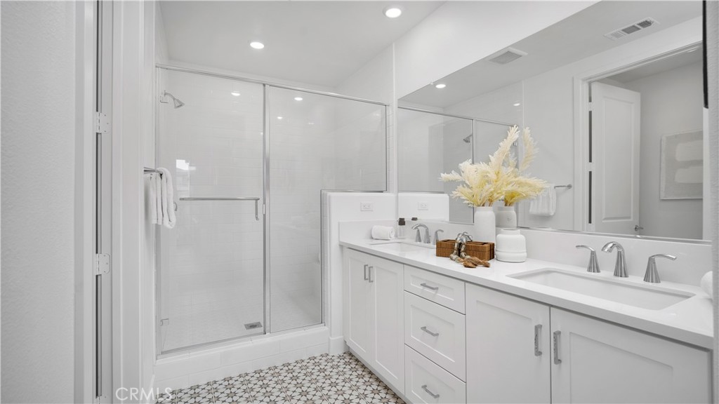 113 Junco Irvine, CA 92618 - Photo 22 of 47 a bathroom with a double vanity sink mirror and shower