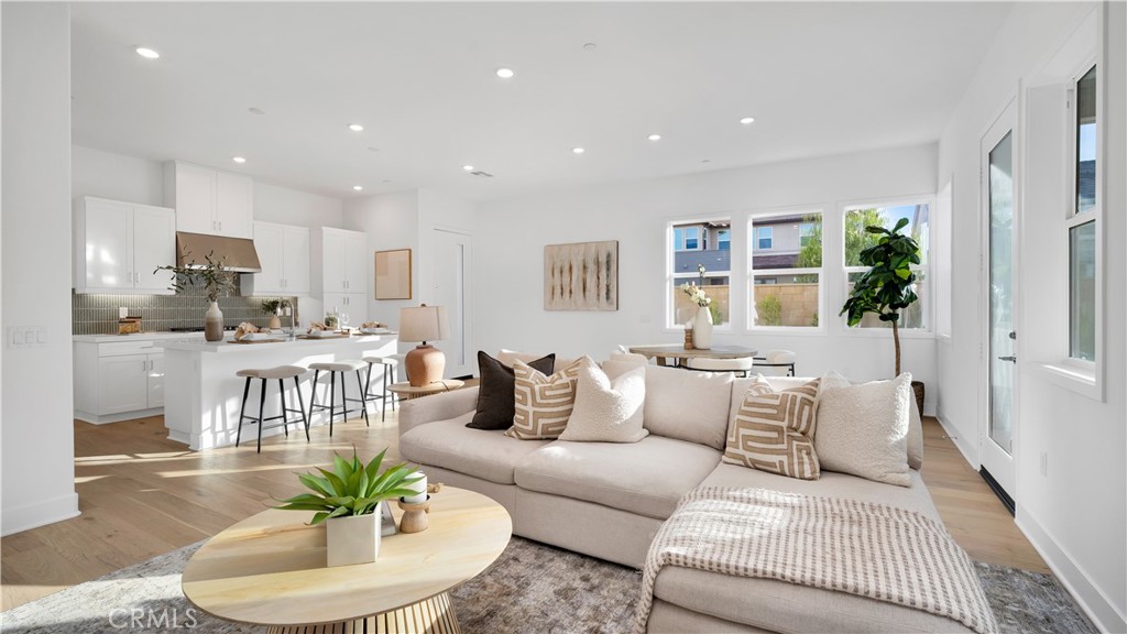 113 Junco Irvine, CA 92618 - Photo 8 of 47 a living room with furniture and a dining table with wooden floor