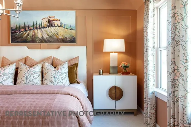 a bedroom with a bed and a painting on the wall