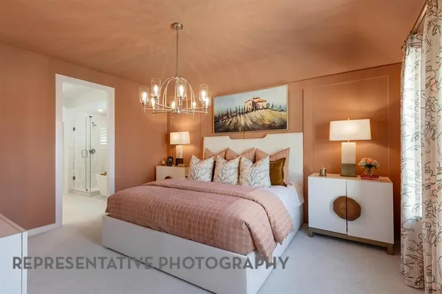 a bedroom with a bed and a chandelier