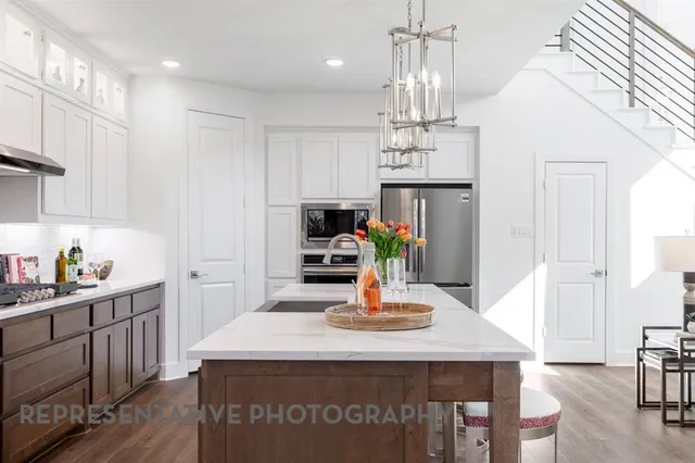 a kitchen with kitchen island a sink and appliances