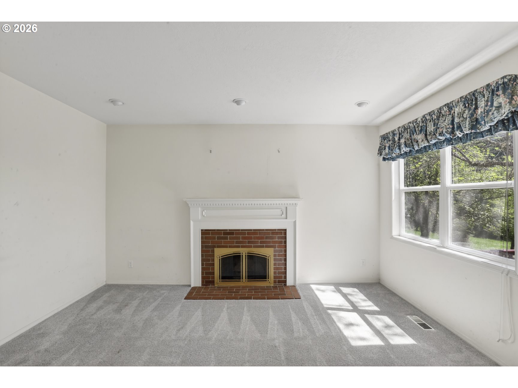 33498 Smith Road St. Helens, OR 97051 - Photo 13 of 34 a view of an empty room with a fireplace and a window