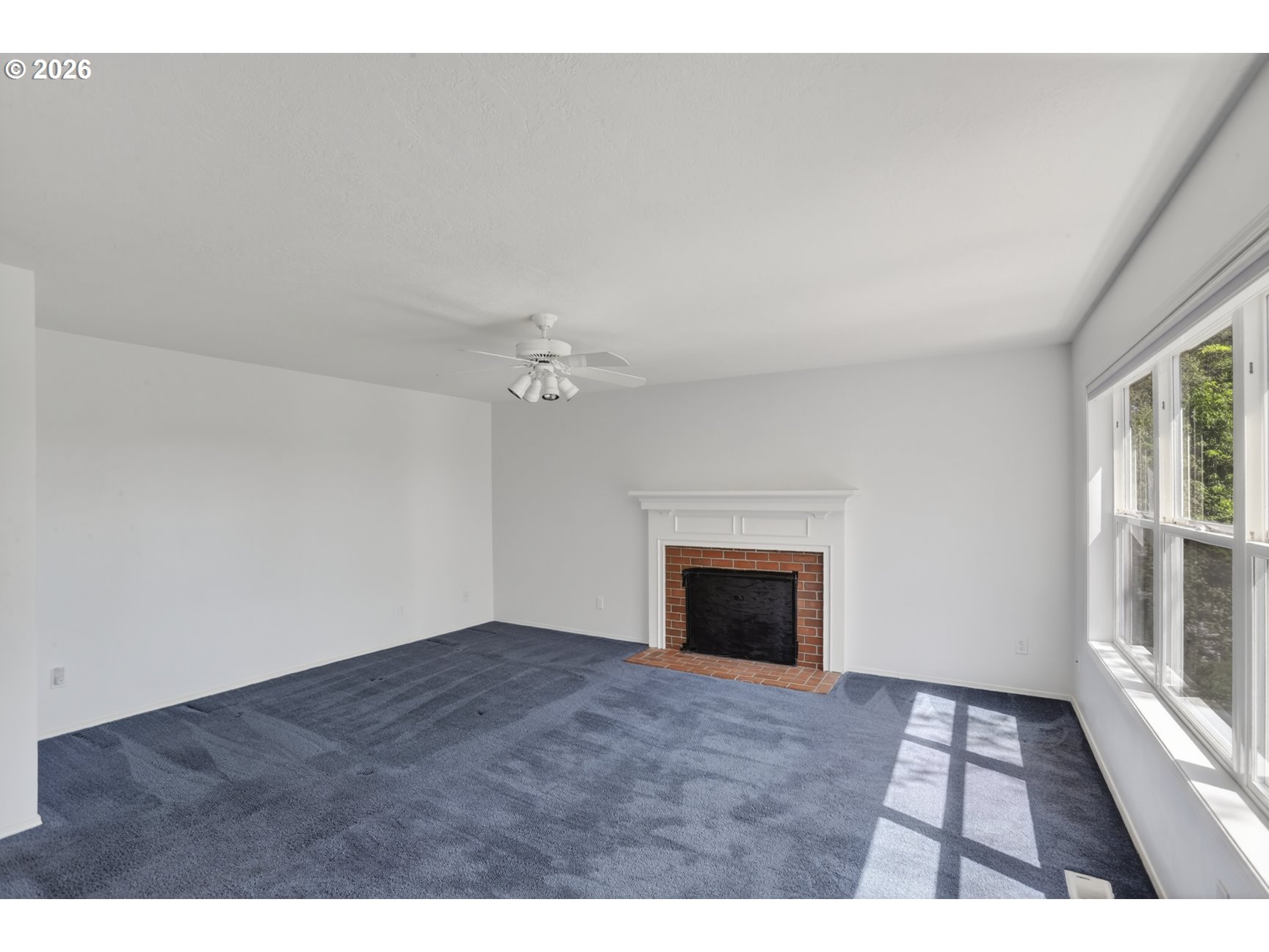 33498 Smith Road St. Helens, OR 97051 - Photo 15 of 34 a view of an empty room with a fireplace and a window