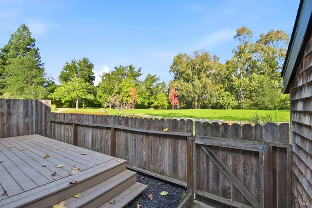 a view of a wooden deck and a yard