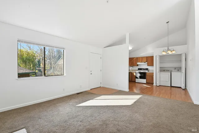 a view of a kitchen and kitchen with furniture cabinets and window
