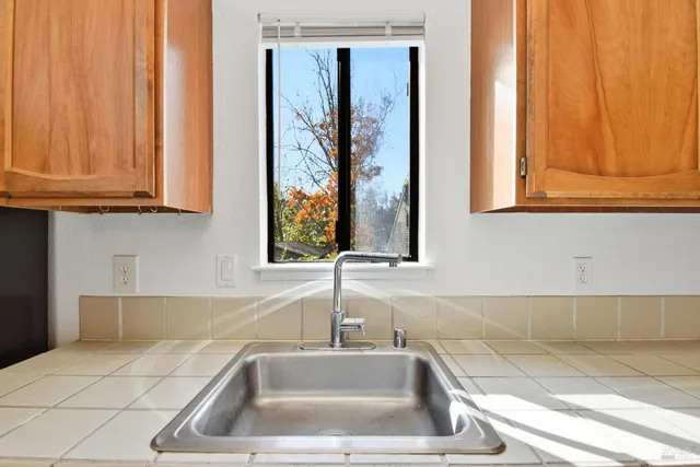 a view of a kitchen with wooden floor and electronic appliances