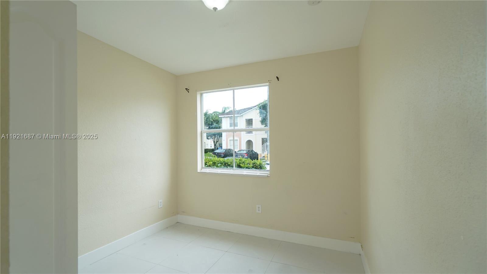 1535 Southeast 26th Street, Unit 103 Homestead, FL 33035 - Photo 11 of 26 an empty room with a window