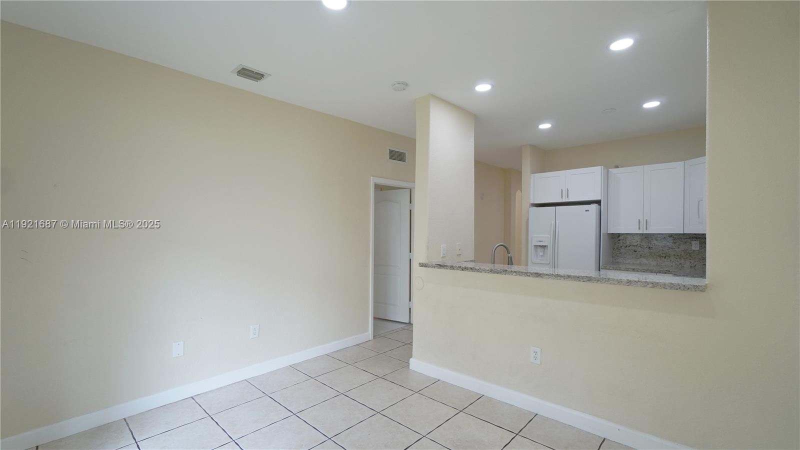 1535 Southeast 26th Street, Unit 103 Homestead, FL 33035 - Photo 16 of 26 a view of a kitchen with white cabinets