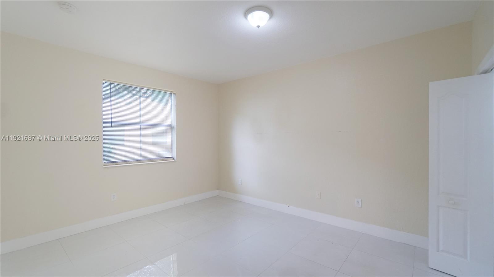 1535 Southeast 26th Street, Unit 103 Homestead, FL 33035 - Photo 19 of 26 an empty room with a window