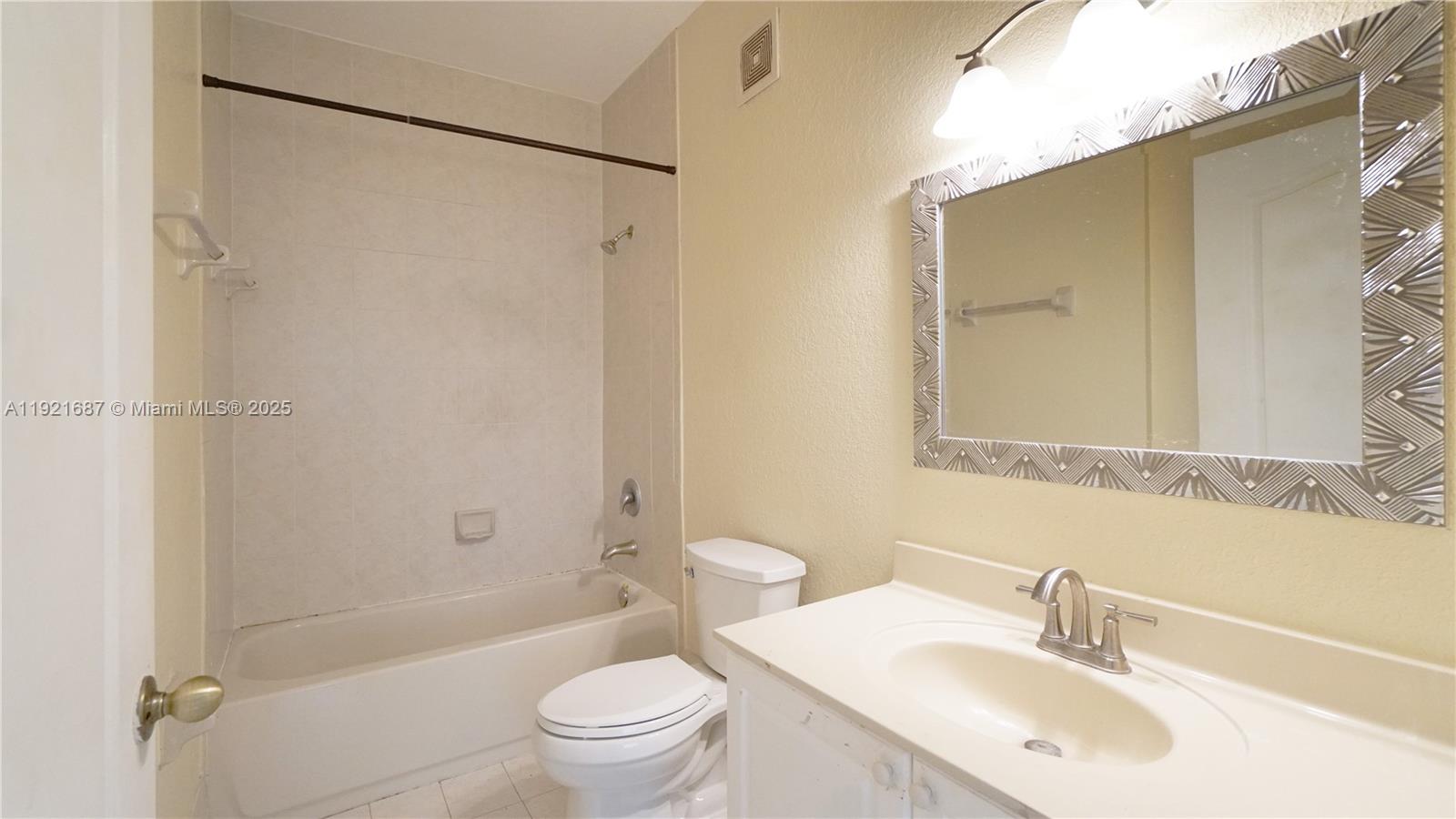 1535 Southeast 26th Street, Unit 103 Homestead, FL 33035 - Photo 23 of 26 a bathroom with a sink toilet and shower