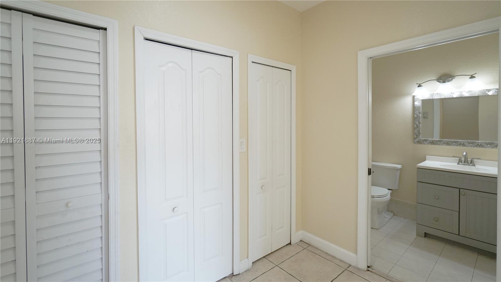 1535 Southeast 26th Street, Unit 103 Homestead, FL 33035 - Photo 6 of 26 a bathroom with a double vanity sink and a mirror