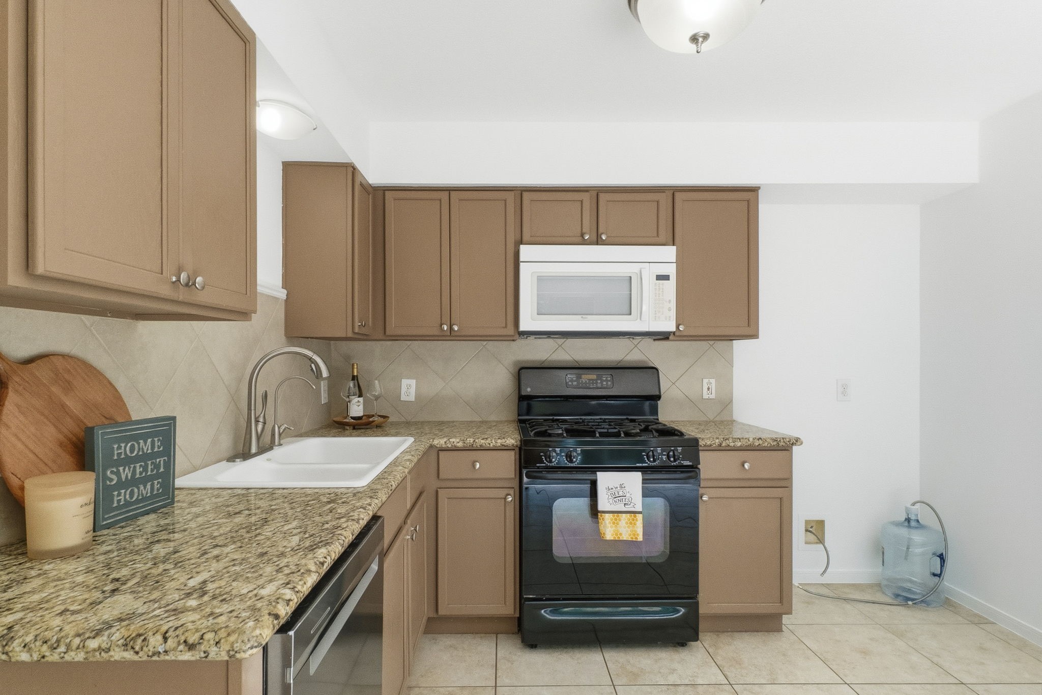 11907 Ezekiel Road Tomball, TX 77375 - Photo 17 of 39 a kitchen with kitchen island granite countertop a sink stove and cabinets