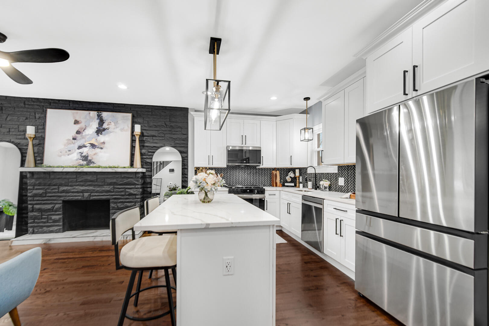 4354 Washington Street Gary, IN 46408 - Photo 10 of 32 a kitchen with stainless steel appliances kitchen island granite countertop a refrigerator a stove and a sink with wooden floor