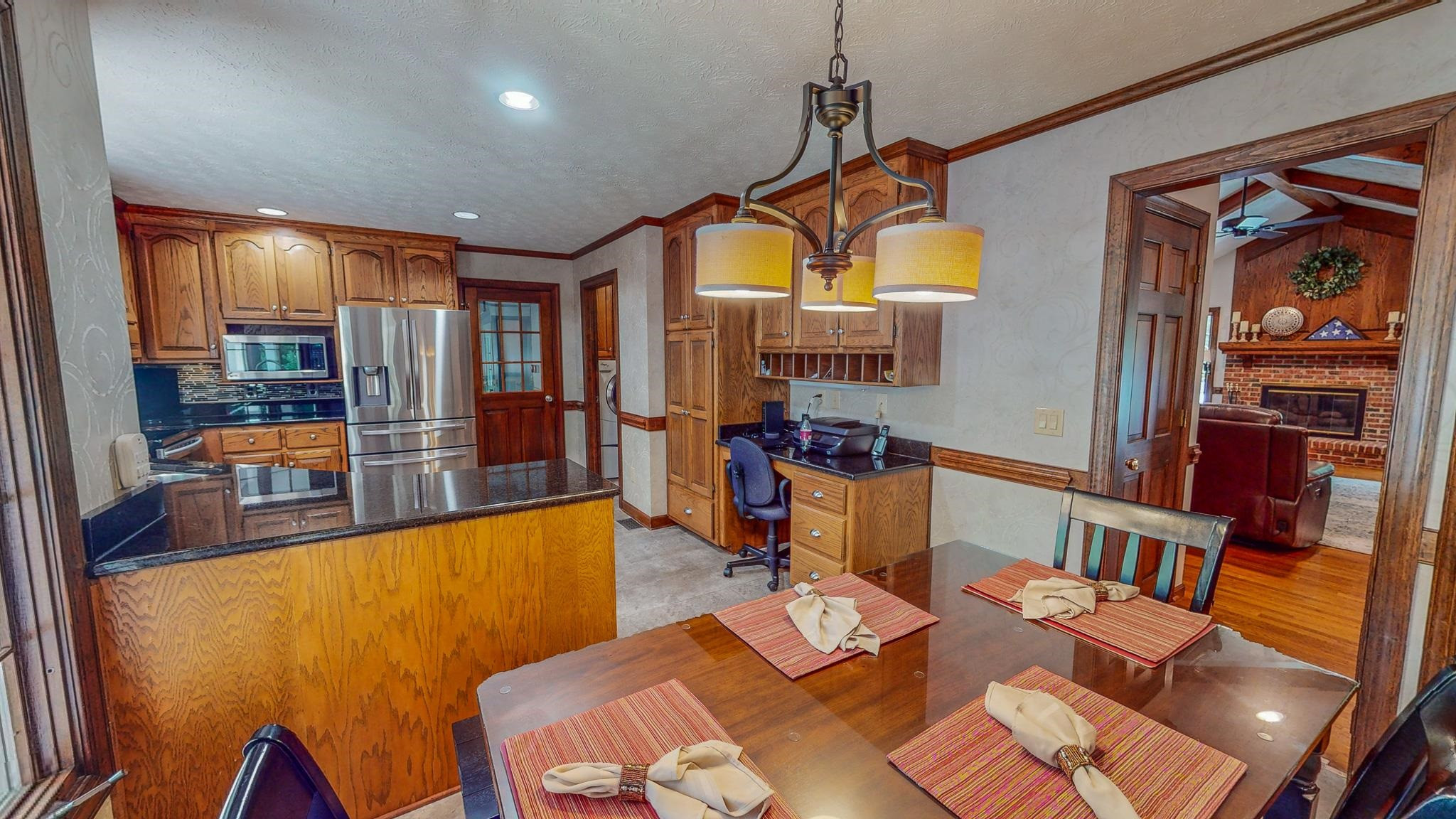 415 North Ridge Circle Roxboro, NC 27574 - Photo 17 of 59 a view of a dining room with furniture a chandelier and wooden floor