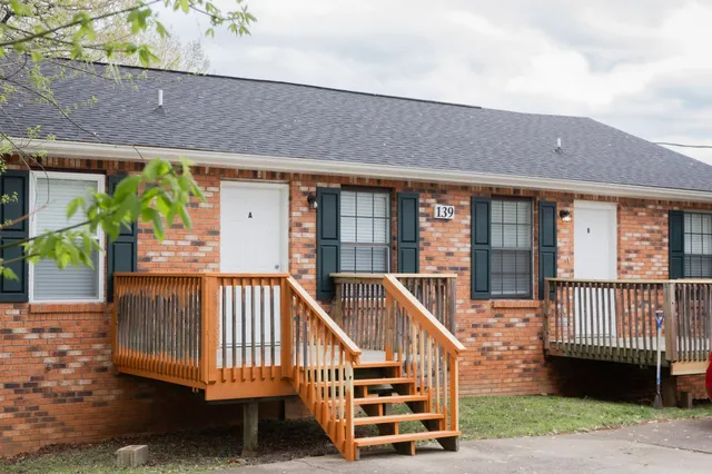 a view of a house with a deck front of house