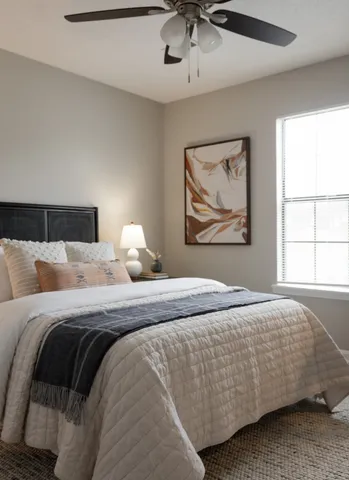 a bedroom with a large bed and a window