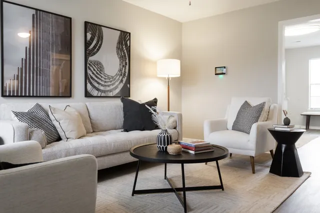 a living room with furniture and a lamp