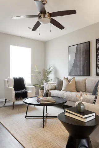 a living room with furniture and a lamp