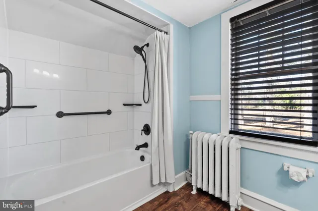 a bathroom with a bathtub and a shower