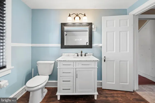 a bathroom with a toilet sink and mirror