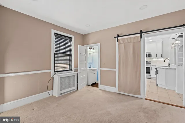 a view of a kitchen with a sink and refrigerator