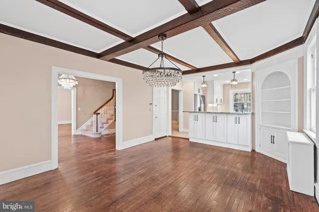 a view of a room with wooden floor and windows
