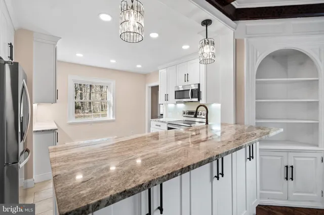 a view of a kitchen with a sink and dishwasher with wooden floor