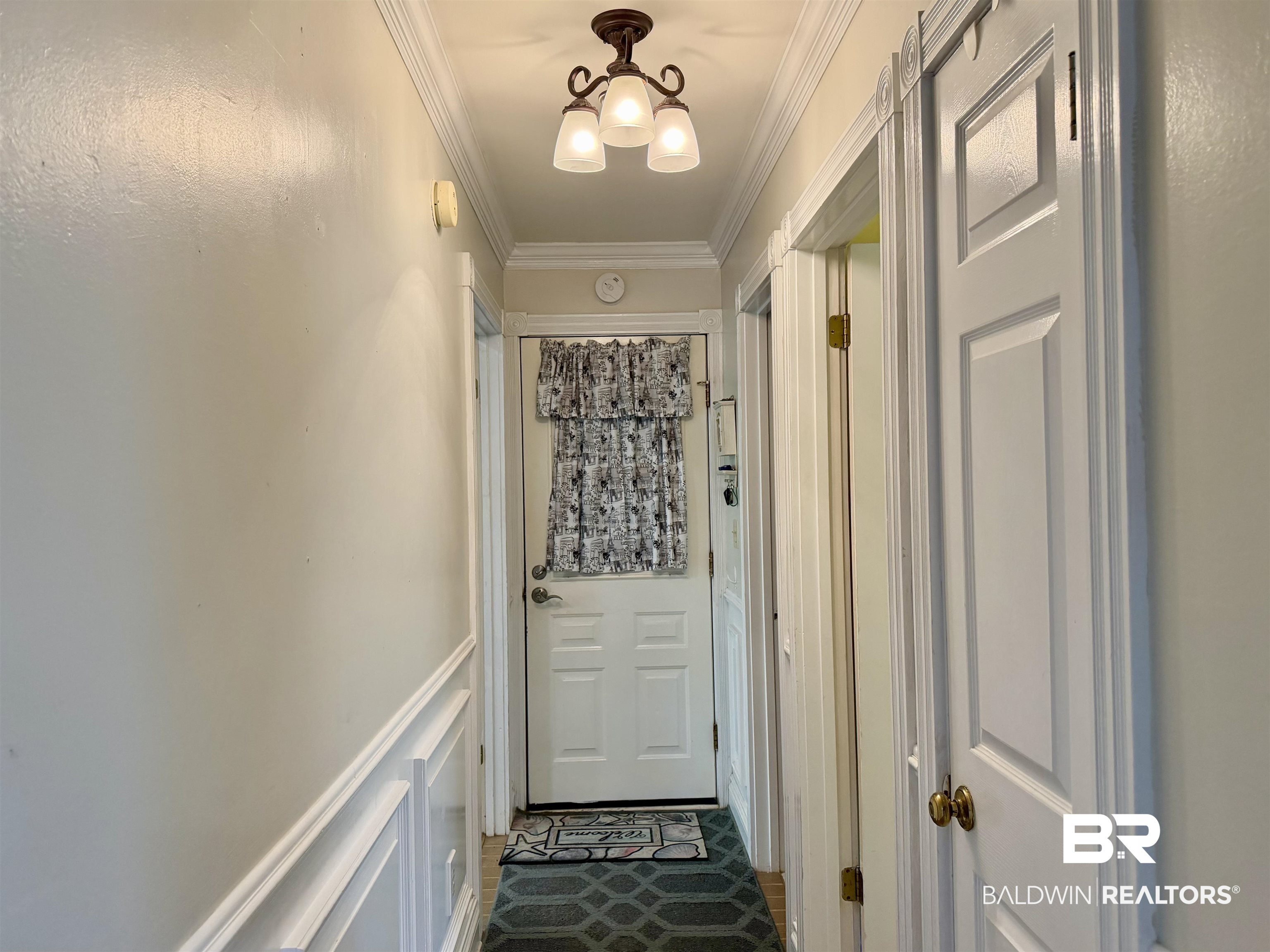 2944 Appleton Road Brewton, AL 36426 - Photo 29 of 65 Doorway to outside featuring crown molding and a decorative wall