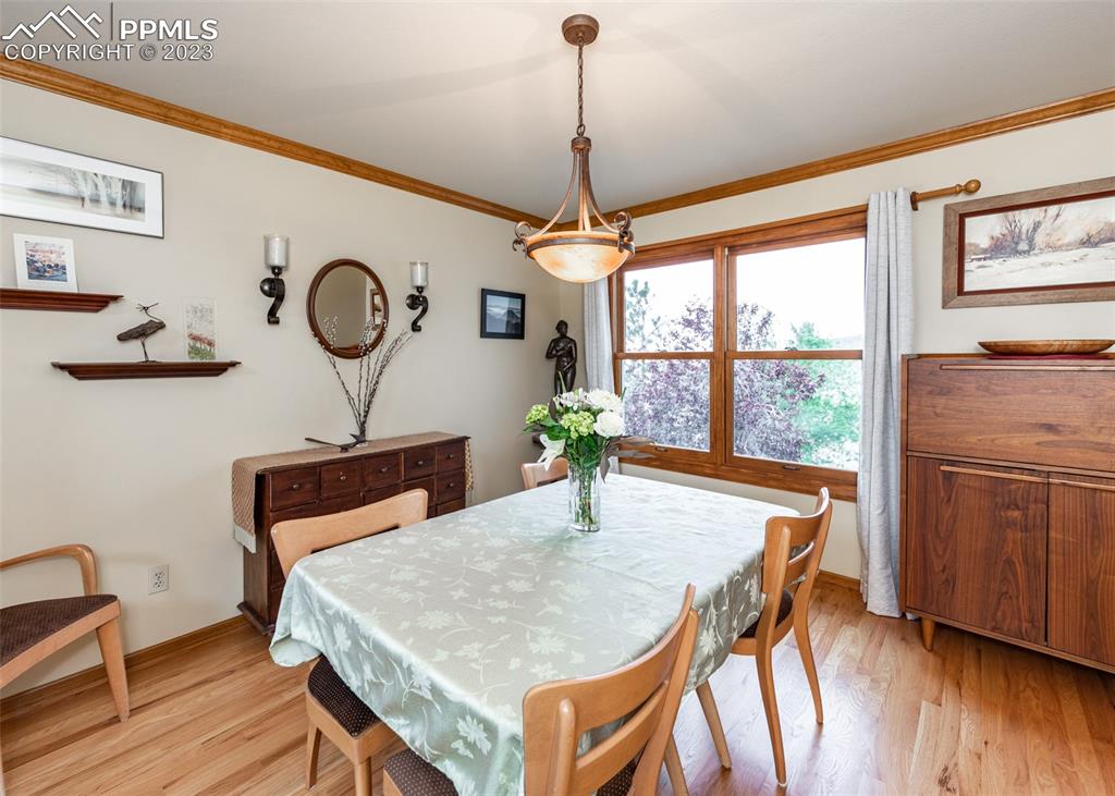 2145 Wickes Road Colorado Springs, CO 80919 - Photo 12 of 50 a view of a dining room with furniture window and wooden floor