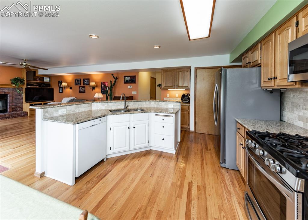 2145 Wickes Road Colorado Springs, CO 80919 - Photo 15 of 50 a kitchen with stainless steel appliances granite countertop a stove and a refrigerator