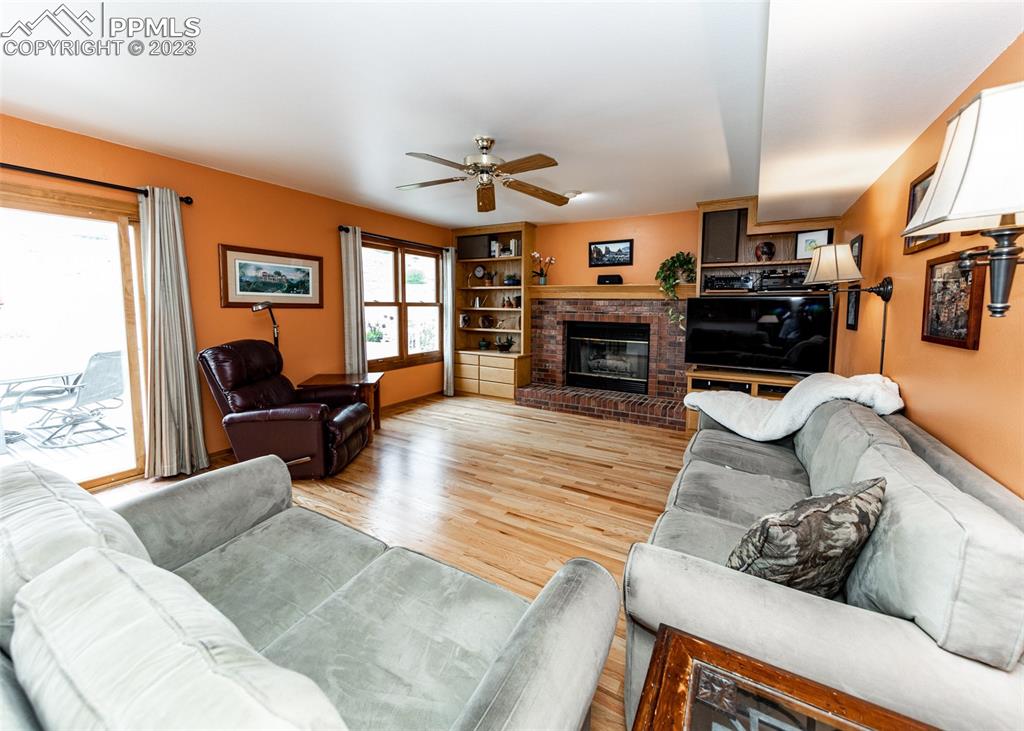 2145 Wickes Road Colorado Springs, CO 80919 - Photo 19 of 50 a living room with furniture fireplace and a flat screen tv