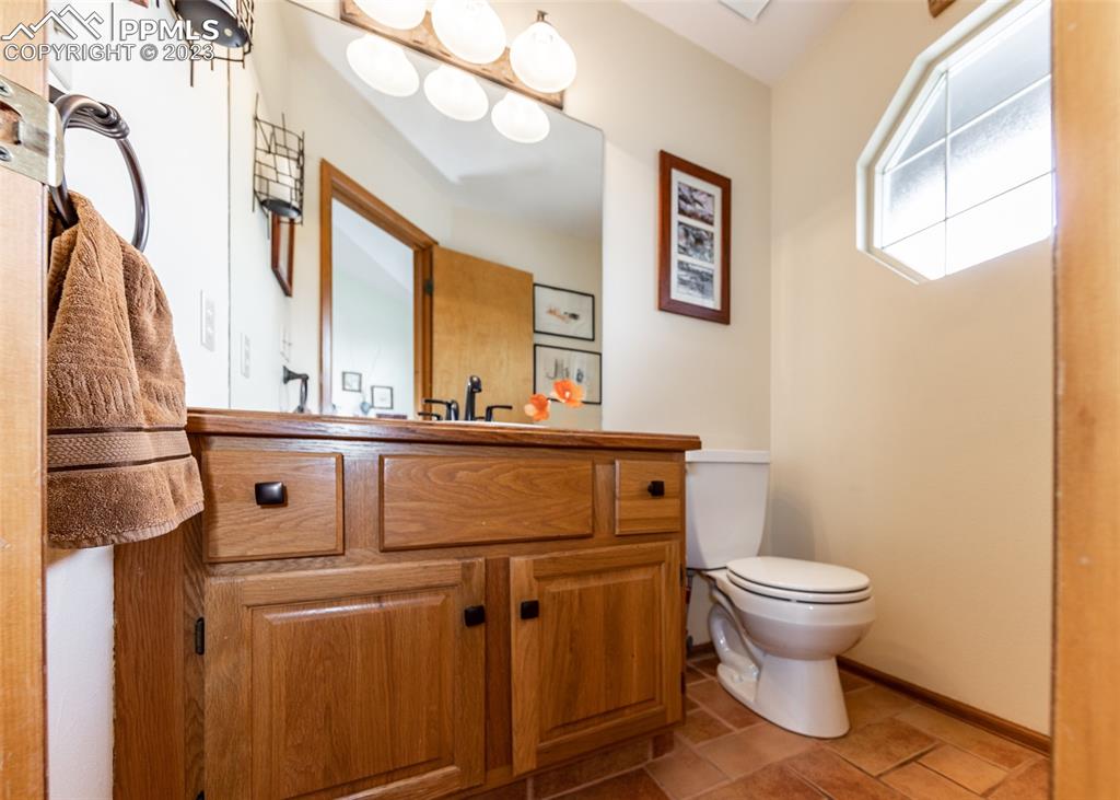 2145 Wickes Road Colorado Springs, CO 80919 - Photo 22 of 50 a bathroom with a toilet sink and mirror