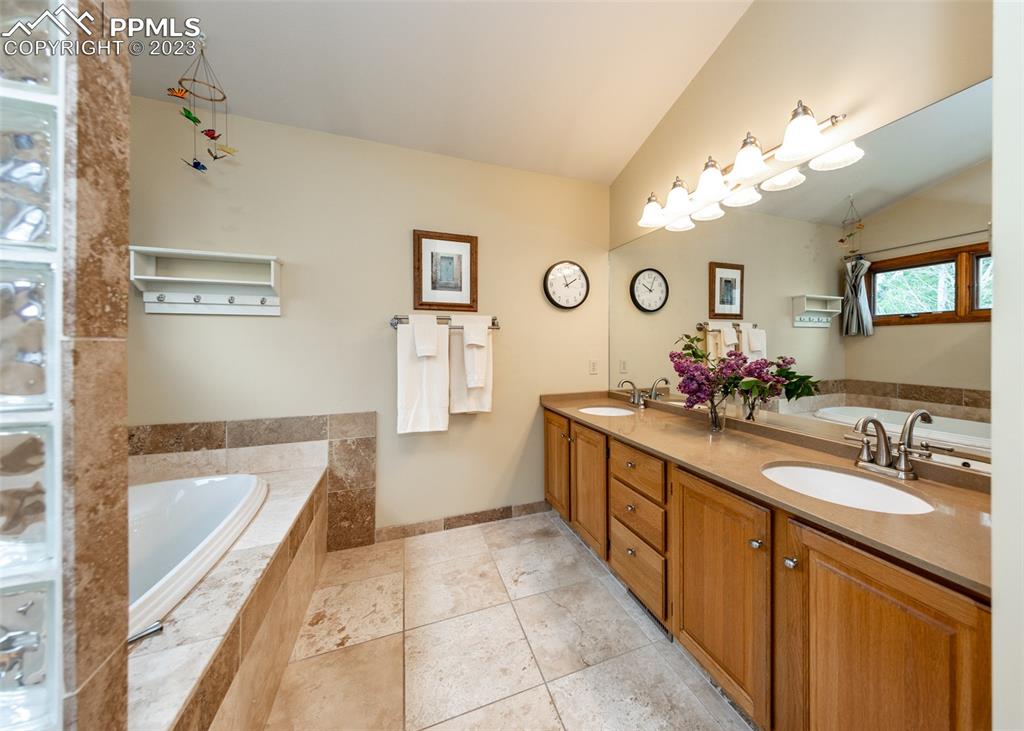 2145 Wickes Road Colorado Springs, CO 80919 - Photo 26 of 50 a spacious bathroom with a tub sink and a mirror