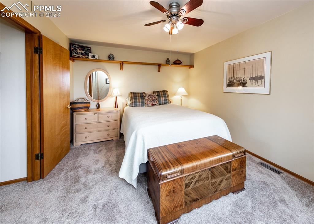 2145 Wickes Road Colorado Springs, CO 80919 - Photo 29 of 50 a bedroom with a bed and lamp