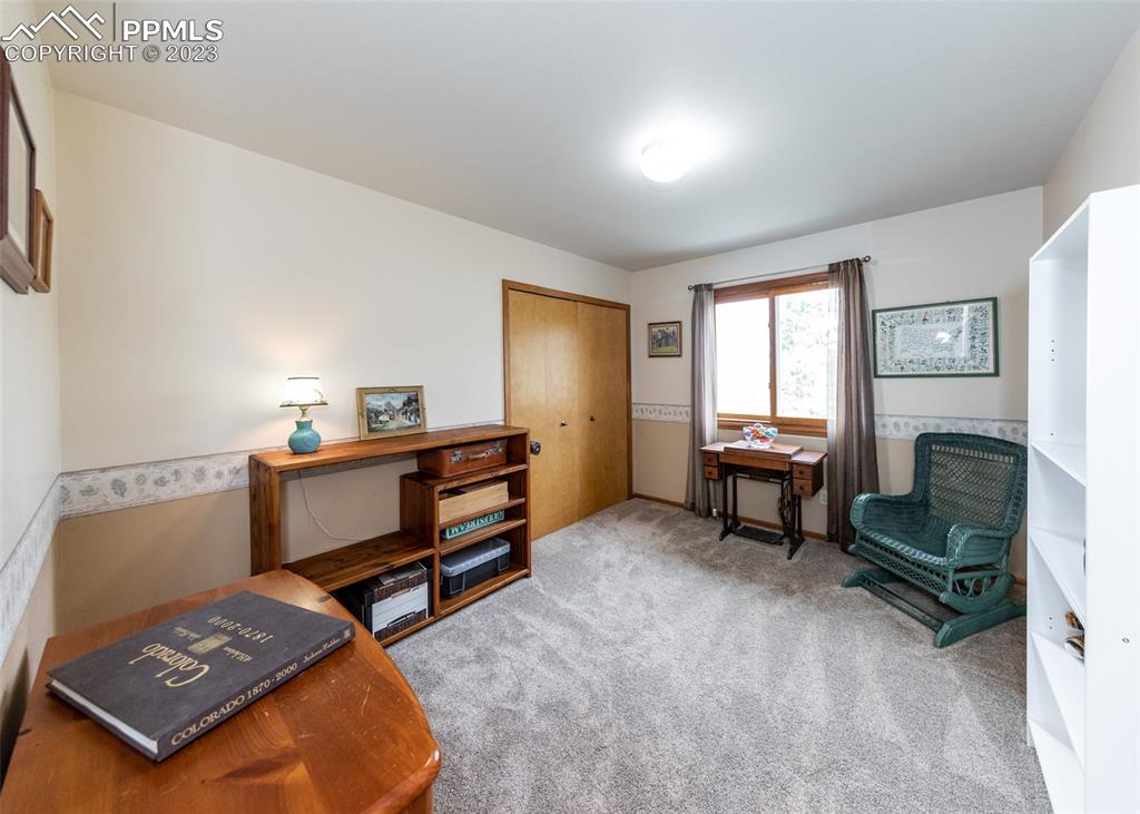 2145 Wickes Road Colorado Springs, CO 80919 - Photo 30 of 50 a bedroom with furniture and a fireplace