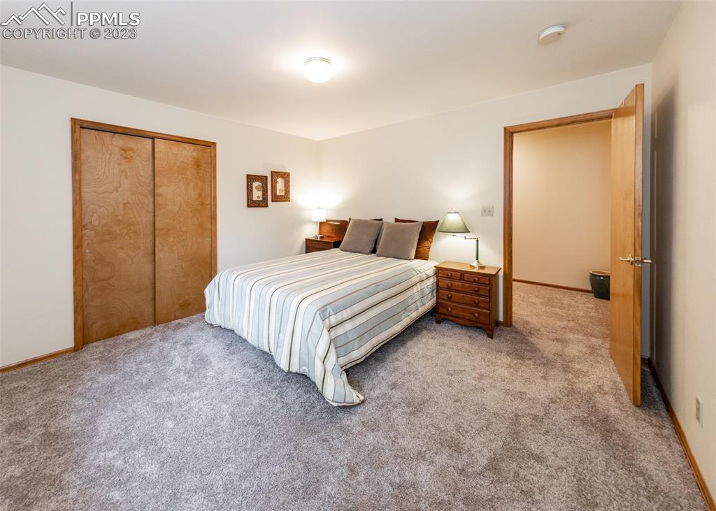 2145 Wickes Road Colorado Springs, CO 80919 - Photo 36 of 50 a bedroom with a bed and a cabinets