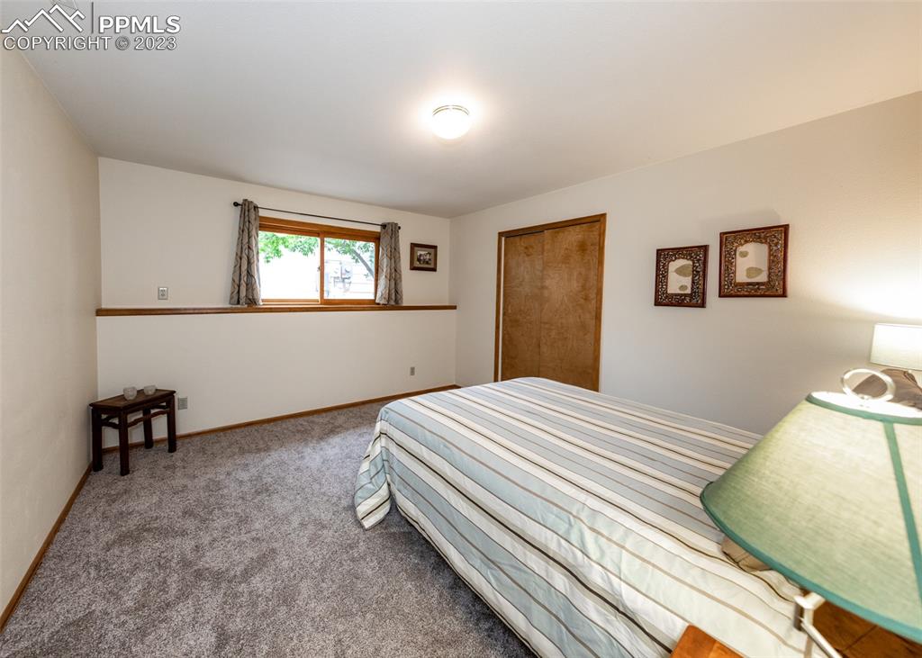 2145 Wickes Road Colorado Springs, CO 80919 - Photo 37 of 50 a bedroom with a bed and a window