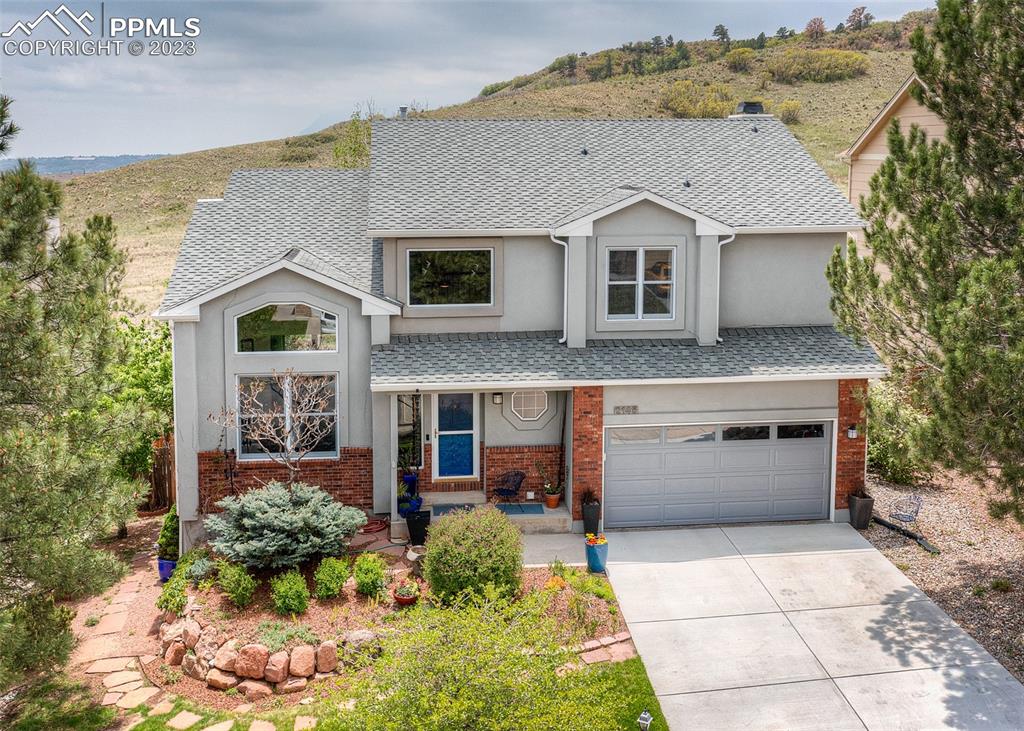 2145 Wickes Road Colorado Springs, CO 80919 - Photo 50 of 50 a front view of a house with a yard and garage
