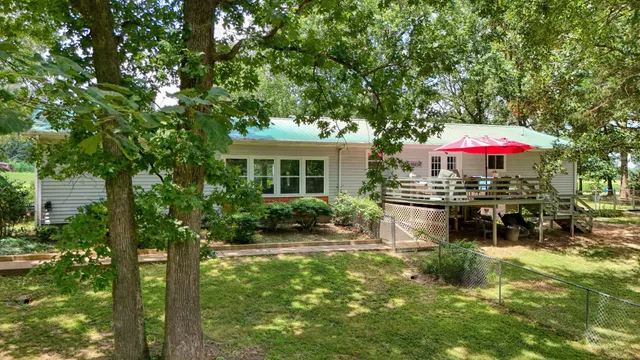 a view of a house with backyard sitting area and garden