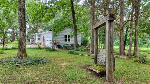 a view of backyard of house with green space