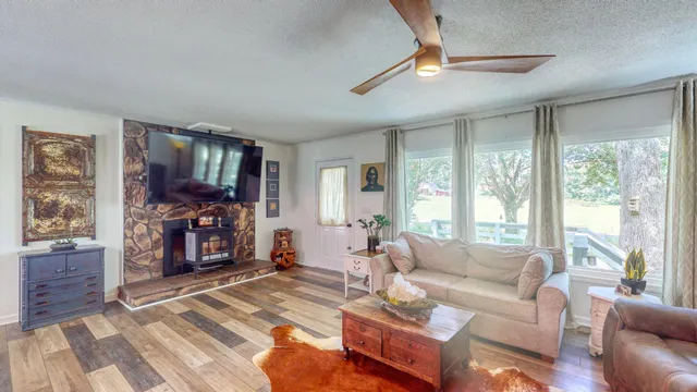 a living room with furniture a large window and a flat screen tv