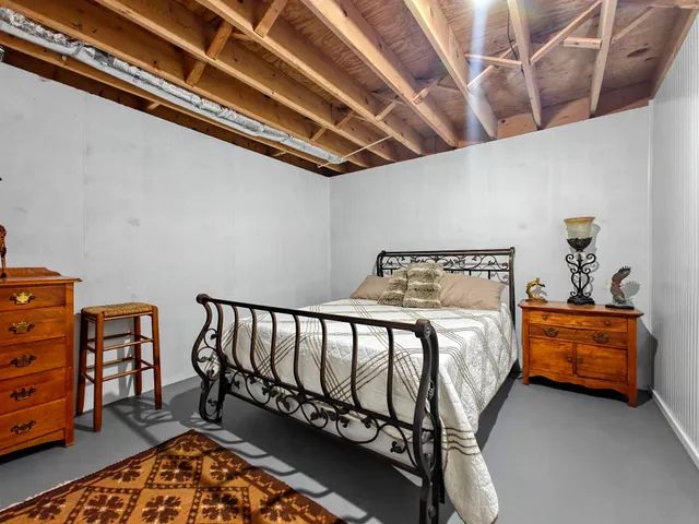 a bed room with a bed and a chair