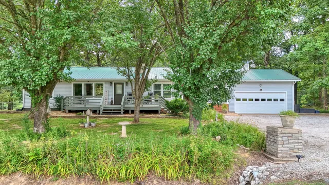 a view of a house with backyard porch and sitting area