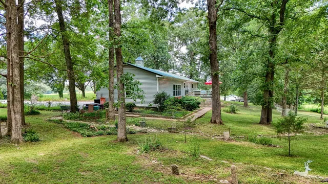 a view of a house with backyard and sitting area