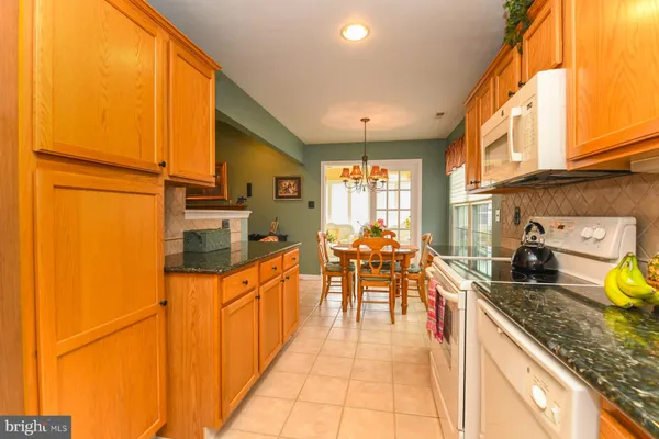 a kitchen with sink refrigerator and cabinets