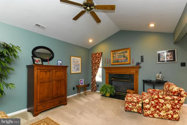 a bedroom with furniture and a fireplace