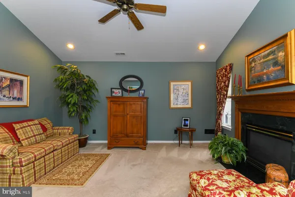 a living room with furniture a window and a fireplace