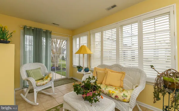 a living room with furniture and floor to ceiling windows